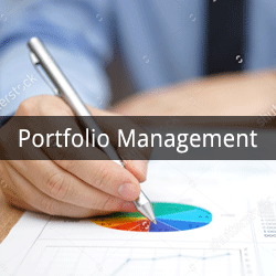 A hand holding a pen drawing a pie chart on a white paper.